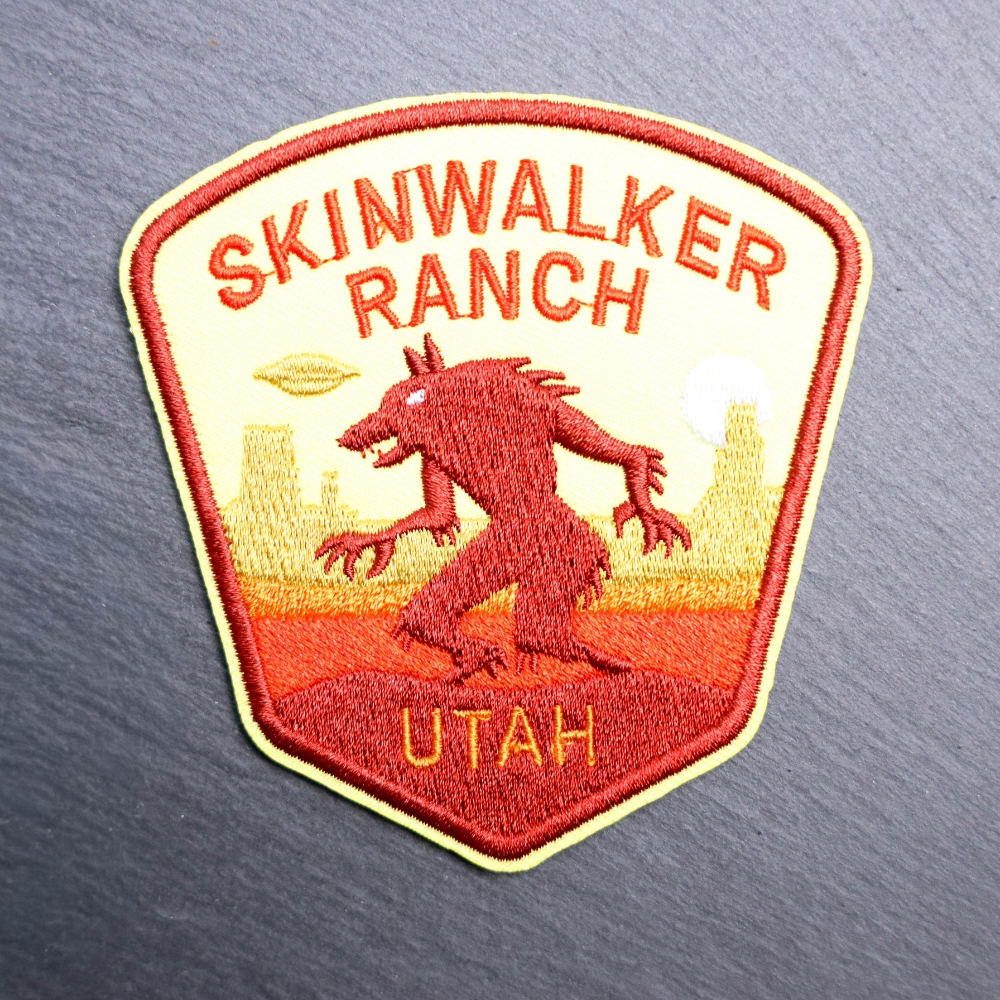 Utah Skinwalker Patch with yellow and orange with a desert backdrop. Beautifully embroidered design with an adhesive for easy application to your favorite bag or article of clothing.