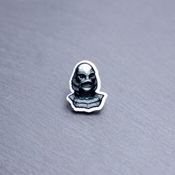 Creature Acrylic Pin. These acrylic pins are made with cast acrylic. These pins are colorful, with a black pin back.