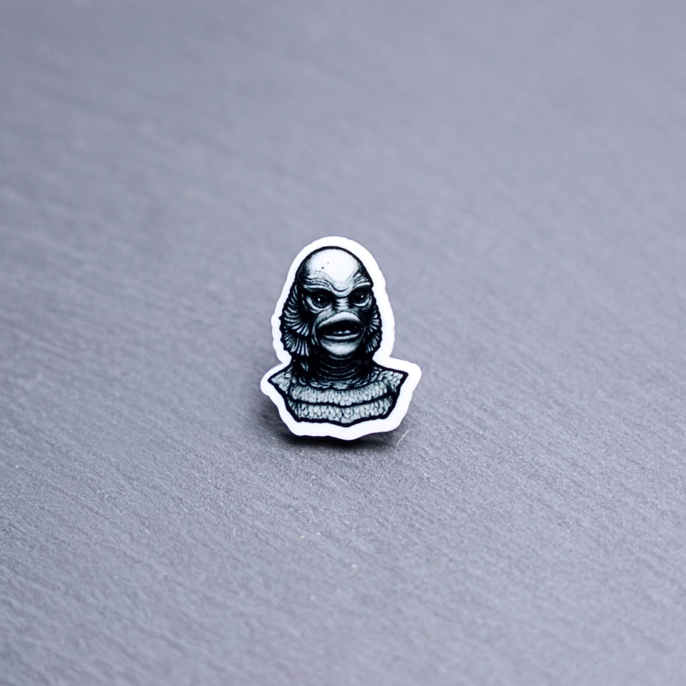 Creature Acrylic Pin. These acrylic pins are made with cast acrylic. These pins are colorful, with a black pin back.