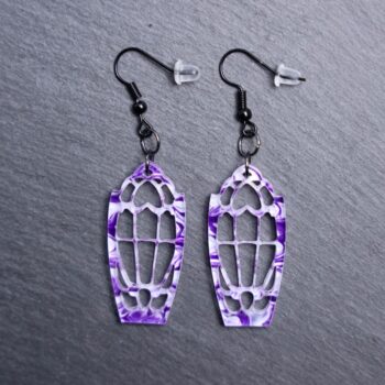 Dracula’s Window Purple Earrings. These earrings are made with white and purple acrylic. Comes with black hooks that is nickel free.