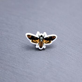 Death Moth Acrylic Pin. These acrylic pins are made with cast acrylic. These pins are colorful, with a black pin back.