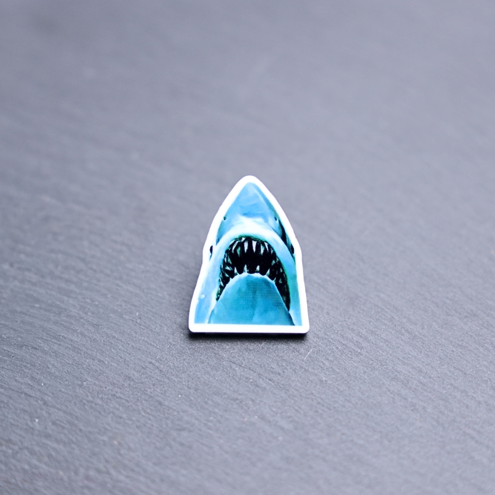 Jaws Acrylic Pin. These acrylic pins are made with cast acrylic. These pins are colorful, with a black pin back.