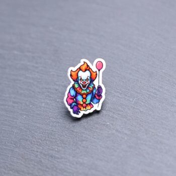 Neon Dancing Clown Acrylic Pin. These acrylic pins are made with cast acrylic. These pins are colorful, with a black pin back.