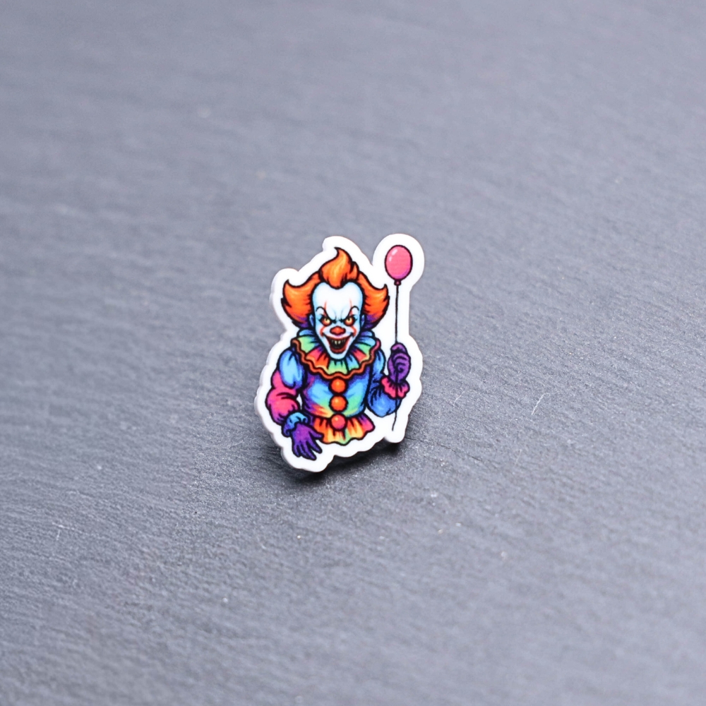 Neon Dancing Clown Acrylic Pin. These acrylic pins are made with cast acrylic. These pins are colorful, with a black pin back.