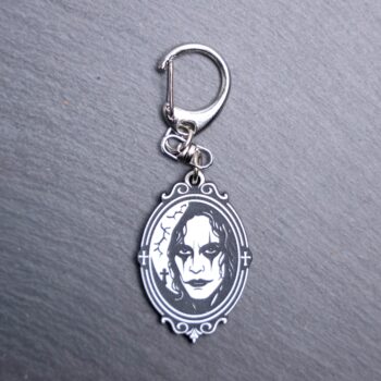 The Crow Bag Tag. This bag tag is made with engraved acrylic. Comes with lobster clasp topper that easily hooks to a bag, zippers, and lanyards for fun display and swivels. Black backside.