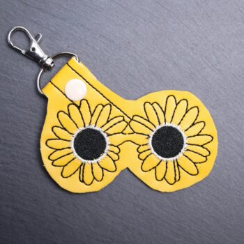 Art Glasses Snap Bag Tag. This bag tag is made with faux vinyl and embroidered. Comes with lobster clasp topper that easily hooks to a bag, zippers