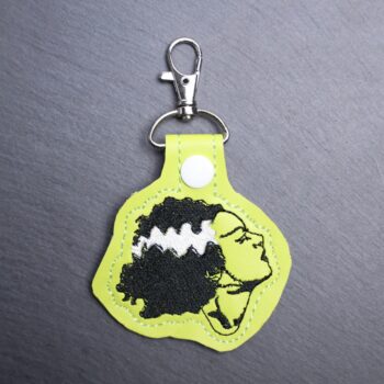 Bride Snap Bag Tag. This bag tag is made with faux vinyl and embroidered. Comes with lobster clasp topper that easily hooks to a bag, zippers