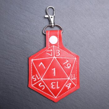 D20 Snap Bag Tag. This bag tag is made with faux vinyl and embroidered. Comes with lobster clasp topper that easily hooks to a bag, zippers