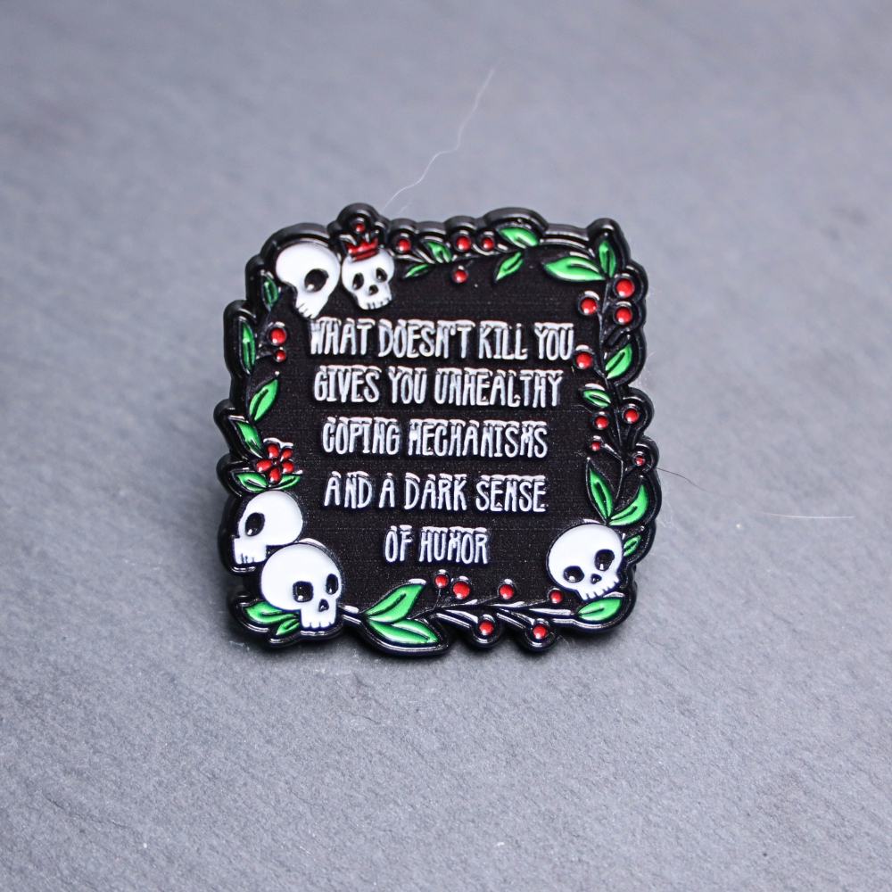 Dark Sense Of Humor Enamel Pin. These enamel pins are made with metal. These enamel pins are colorful, with a black backing.