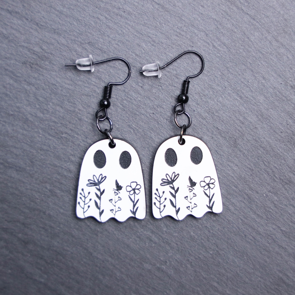 Floral Ghost Earrings that are white and black. These earrings are made with engraved acrylic. Comes with black hooks that is nickel free.