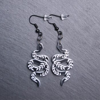 Snake Engraved Earrings that are white and black. These earrings are made with engraved acrylic. Comes with black hooks that is nickel free.