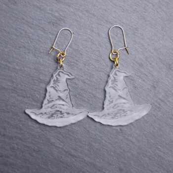 Sorting Hat Engraved Earrings. These earrings are made with clear acrylic. Comes with gold hooks that is nickel free.