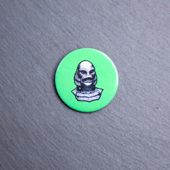 Creature Button. These buttons are made with photo paper, metal round, and metal backing. These buttons are vibrant and fun to use on bags or vests.