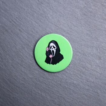 Ghostface Pink Phone Button. These buttons are made with photo paper, metal round, and metal backing. These buttons are vibrant and fun to use on bags or vests.