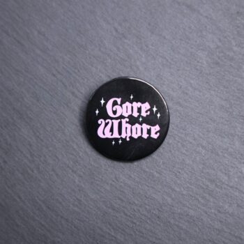 Gore Whore Button. These buttons are made with photo paper, metal round, and metal backing. These buttons are vibrant and fun to use on bags or vests.