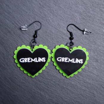 Gremlins Pillow Earrings that are white, black and pink. These earrings are made with engraved acrylic. Comes with black hooks that is nickel free.