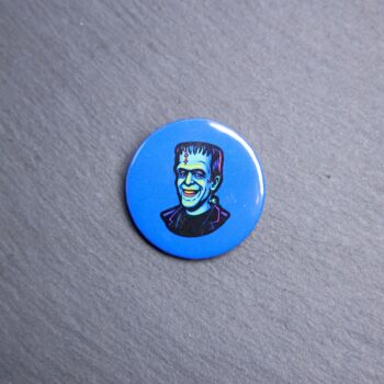 Herman Munster Button. These buttons are made with photo paper, metal round, and metal backing. These buttons are vibrant and fun to use on bags or vests.