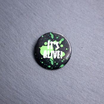 It's Alive Button. These buttons are made with photo paper, metal round, and metal backing. These buttons are vibrant and fun to use on bags or vests.