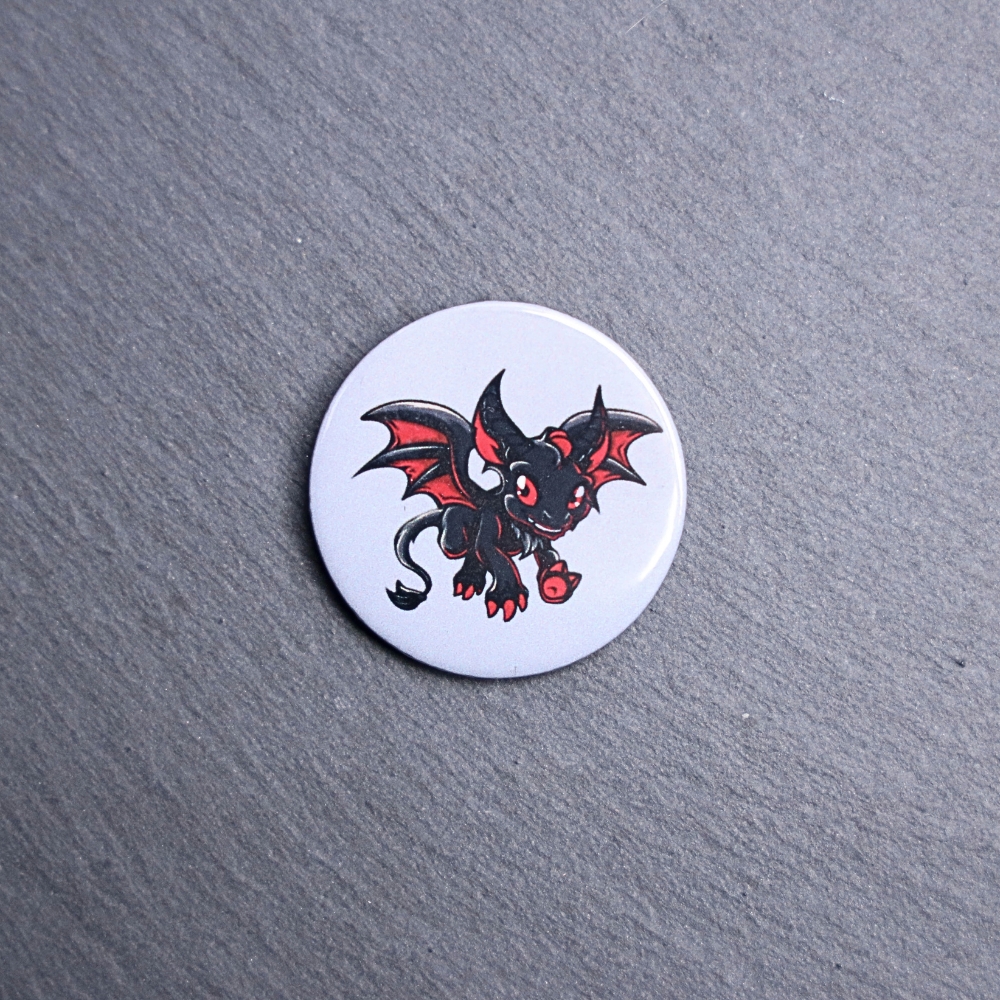 Jersey Devil Button. These buttons are made with photo paper, metal round, and metal backing. These buttons are vibrant and fun to use on bags or vests.