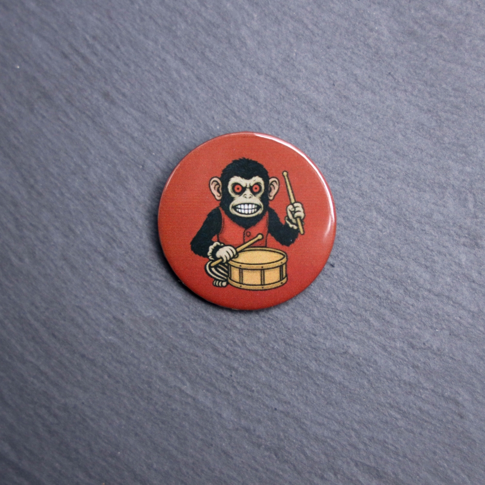 Monkey Button. These buttons are made with photo paper, metal round, and metal backing. These buttons are vibrant and fun to use on bags or vests.