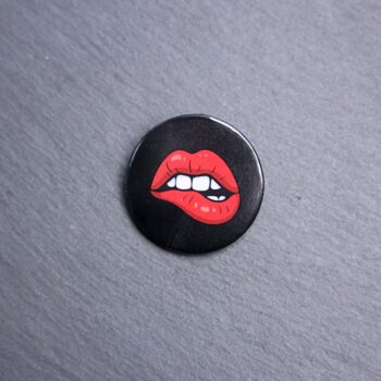 RHPS Lips Button. These buttons are made with photo paper, metal round, and metal backing. These buttons are vibrant and fun to use on bags or vests.