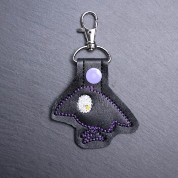 Raven Snap Bag Tag. This bag tag is made with faux vinyl and embroidered. Comes with lobster clasp topper that easily hooks to a bag, zippers