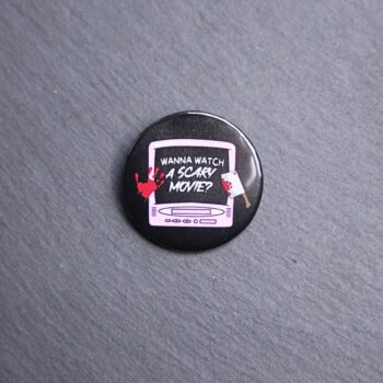 Scary Movie Button. These buttons are made with photo paper, metal round, and metal backing. These buttons are vibrant and fun to use on bags or vests.
