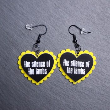 Silence Of The Lambs Pillow Earrings that are white, black and yellow. These earrings are made with engraved acrylic. Comes with black hooks that is nickel free.