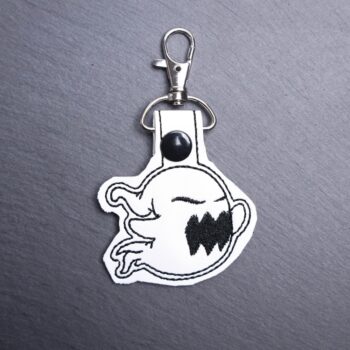 Spooky Ghost Snap Bag Tag. This bag tag is made with faux vinyl and embroidered. Comes with lobster clasp topper that easily hooks to a bag, zippers