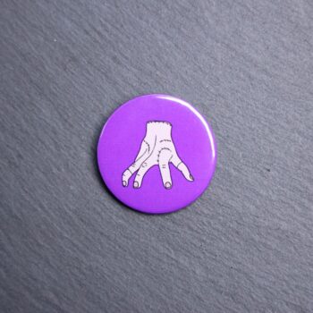 Thing Button. These buttons are made with photo paper, metal round, and metal backing. These buttons are vibrant and fun to use on bags or vests.