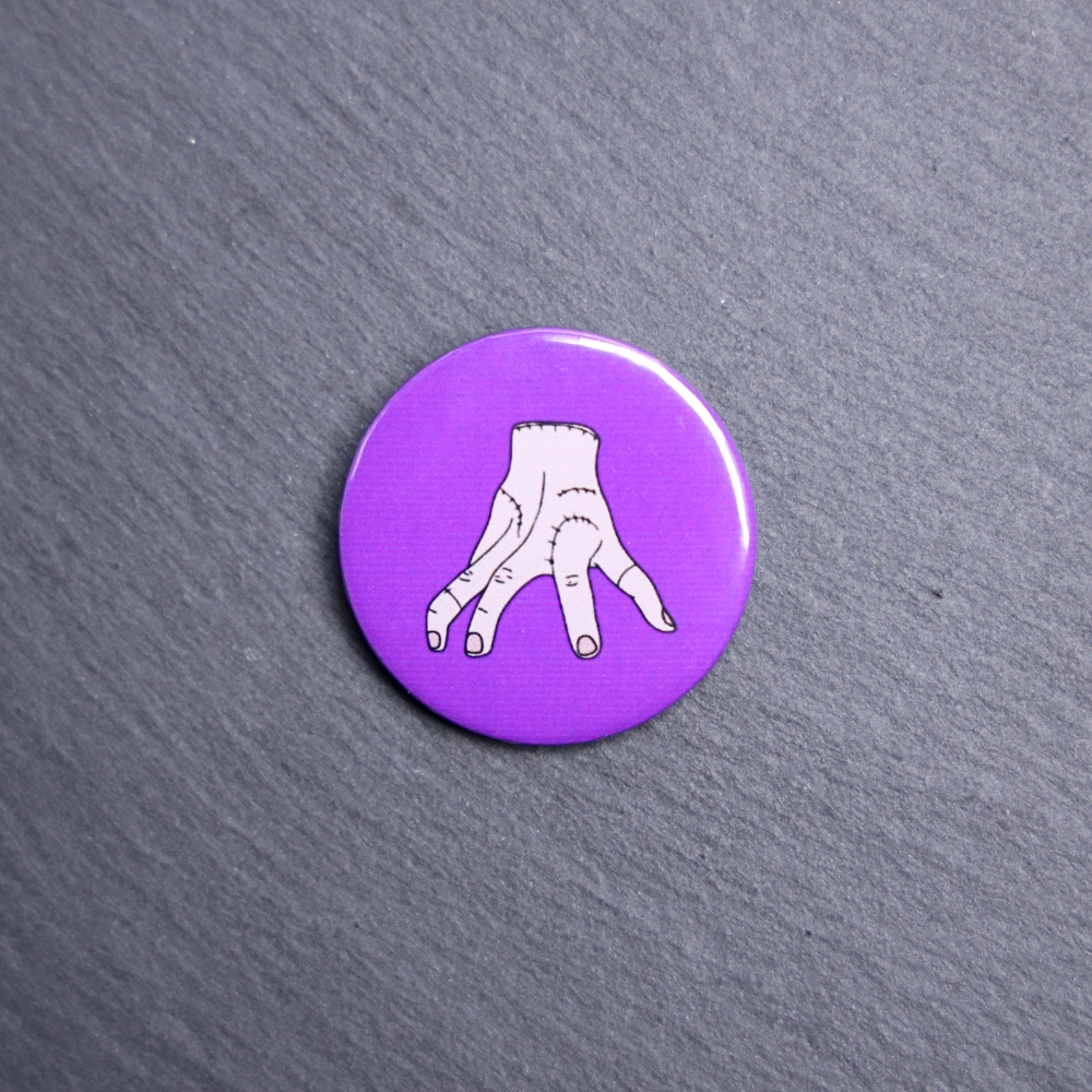 Thing Button. These buttons are made with photo paper, metal round, and metal backing. These buttons are vibrant and fun to use on bags or vests.