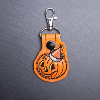 Vintage Jack Snap Bag Tag. This bag tag is made with faux vinyl and embroidered. Comes with lobster clasp topper that easily hooks to a bag, zippers