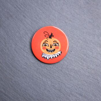 Vintage Pumpkin Button. These buttons are made with photo paper, metal round, and metal backing. These buttons are vibrant and fun to use on bags or vests.