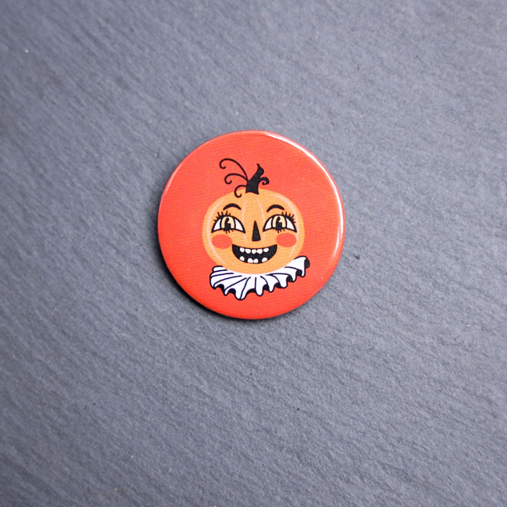 Vintage Pumpkin Button. These buttons are made with photo paper, metal round, and metal backing. These buttons are vibrant and fun to use on bags or vests.
