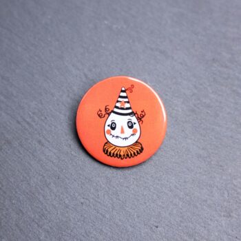 Vintage Scarecrow Button. These buttons are made with photo paper, metal round, and metal backing. These buttons are vibrant and fun to use on bags or vests.
