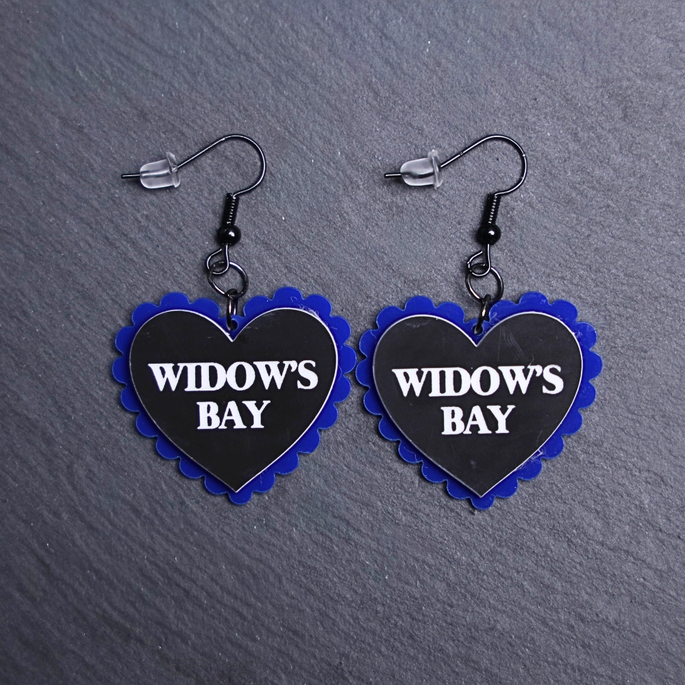 Widow's Bay Pillow Earrings that are white, black and blue. These earrings are made with engraved acrylic. Comes with black hooks that is nickel free.