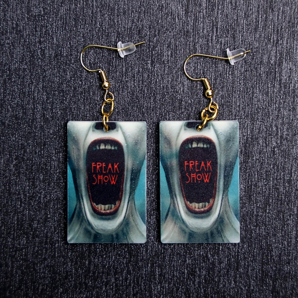 AHS Poster Earrings. These earrings are made with acrylic and hand heat pressed. Comes with 18k plated gold hooks that is nickel free.