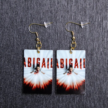 Abigail Poster Earrings. These earrings are made with acrylic and hand heat pressed. Comes with 18k plated gold hooks that is nickel free.