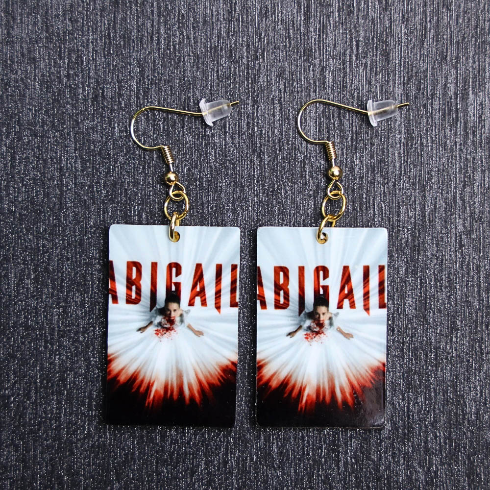 Abigail Poster Earrings. These earrings are made with acrylic and hand heat pressed. Comes with 18k plated gold hooks that is nickel free.