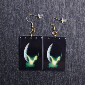 Alien Poster Earrings. These earrings are made with acrylic and hand heat pressed. Comes with 18k plated gold hooks that is nickel free.