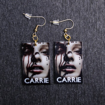 Carrie Poster Earrings. These earrings are made with acrylic and hand heat pressed. Comes with 18k plated gold hooks that is nickel free. Slightly distressed and reflects in light.