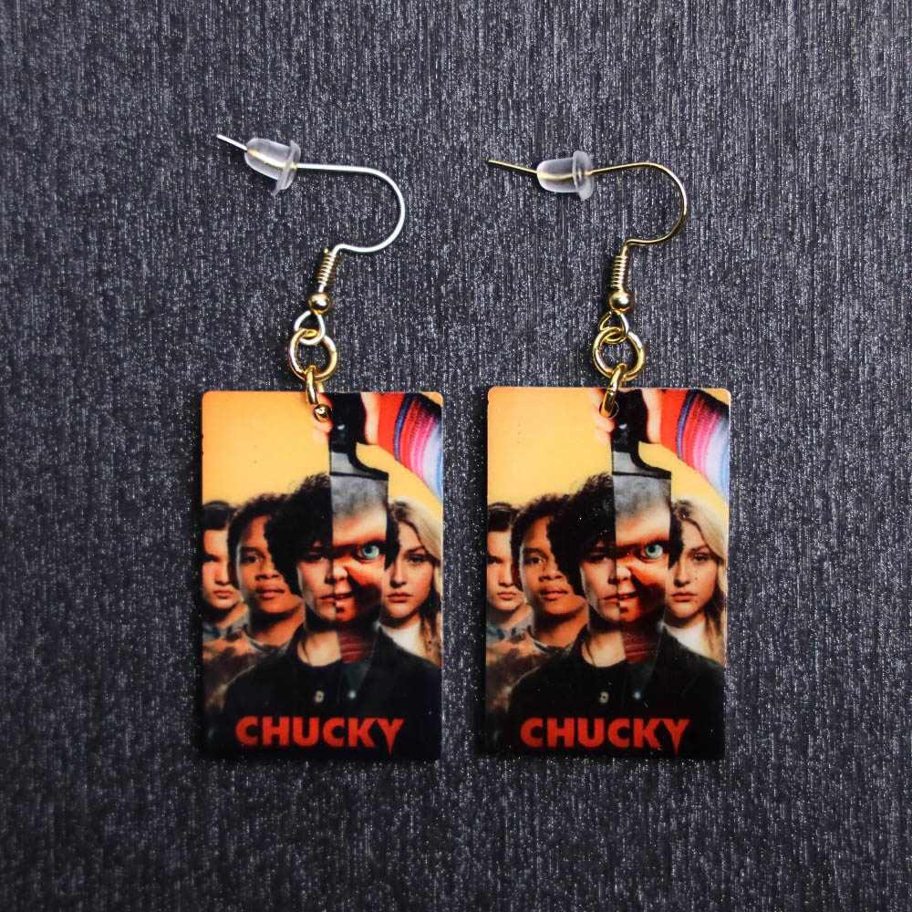 Chucky Show Poster Earrings. These earrings are made with acrylic and hand heat pressed. Comes with 18k plated gold hooks that is nickel free.