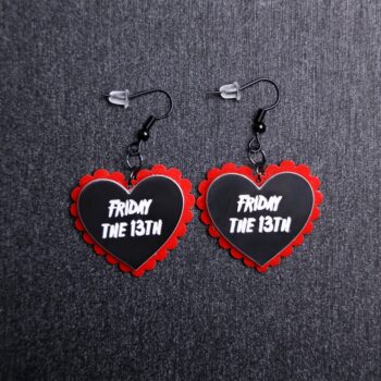 Friday The 13th Pillow Earrings that are white, black and red. These earrings are made with engraved acrylic. Comes with black hooks that is nickel free.