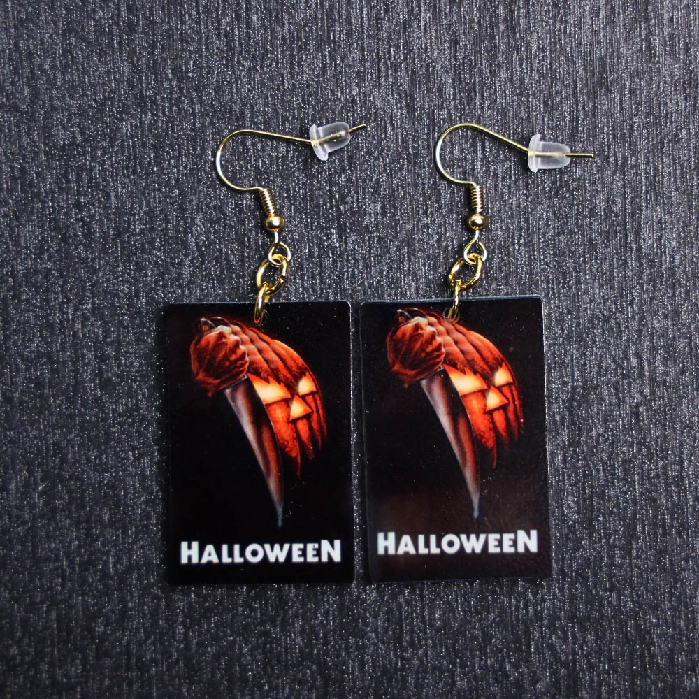 Halloween 1978 Poster Earrings. These earrings are made with acrylic and hand heat pressed. Comes with 18k plated gold hooks that is nickel free.