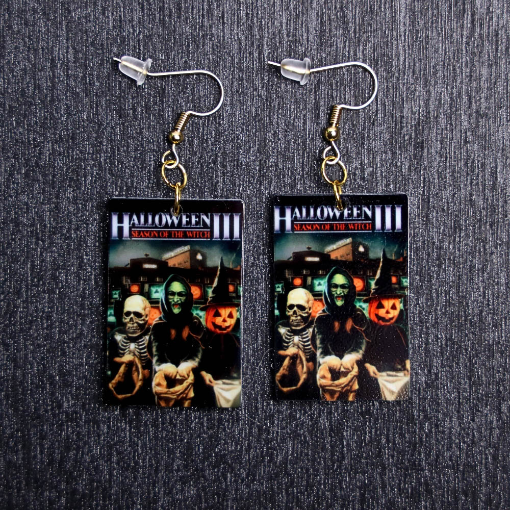Halloween III Poster Earrings. These earrings are made with acrylic and hand heat pressed. Comes with 18k plated gold hooks that is nickel free.