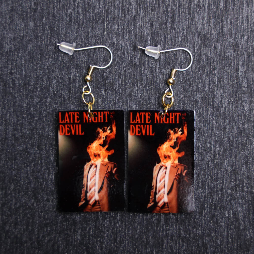 Late Night With The Devil Poster Earrings. These earrings are made with acrylic and hand heat pressed. Comes with 18k plated gold hooks that is nickel free.