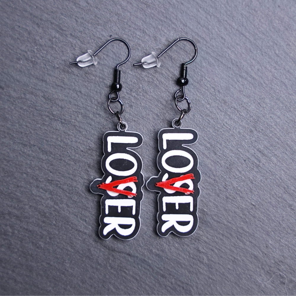 Loser Lover Black Earrings that are white, black and red. These earrings are made with engraved acrylic. Comes with black hooks that is nickel free.