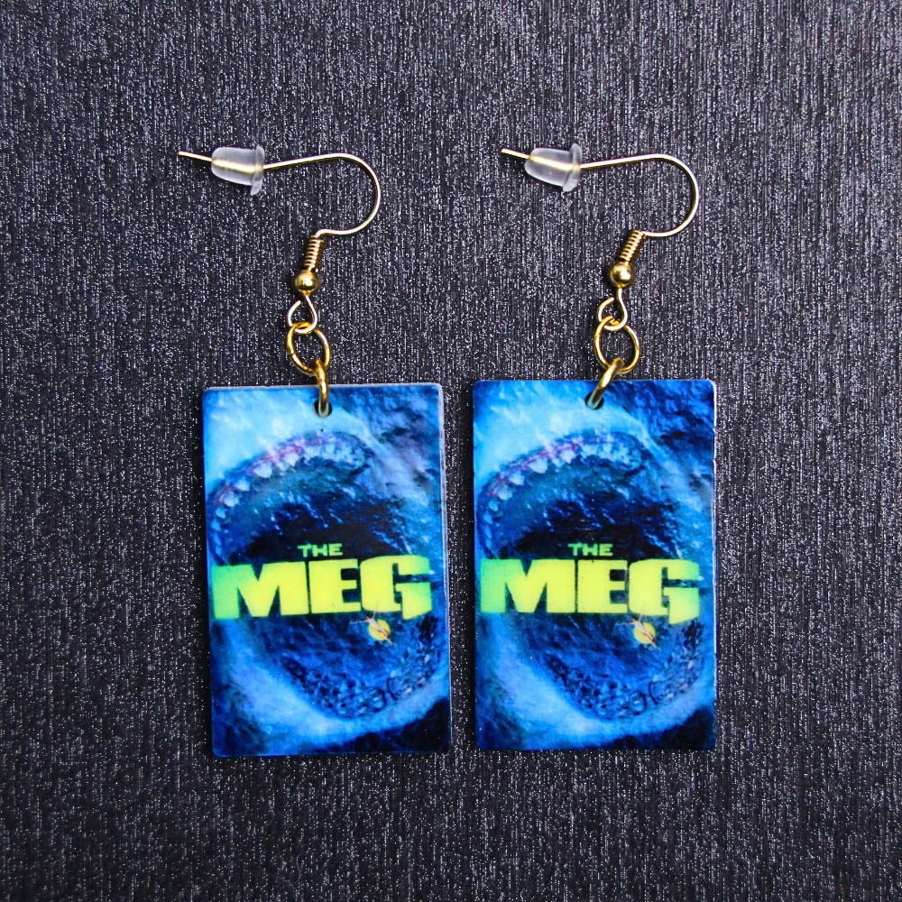 Meg Poster Earrings. These earrings are made with acrylic and hand heat pressed. Comes with 18k plated gold hooks that is nickel free.