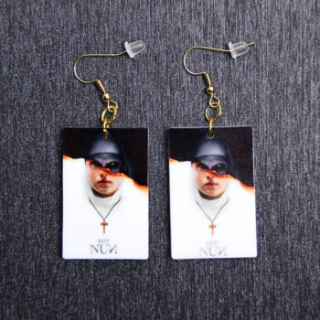 Nun Poster Earrings. These earrings are made with acrylic and hand heat pressed. Comes with 18k plated gold hooks that is nickel free.