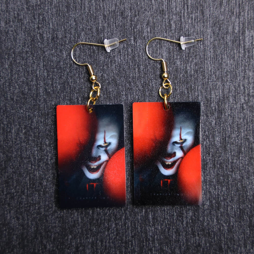 Pennywise IT Poster Earrings. These earrings are made with acrylic and hand heat pressed. Comes with 18k plated gold hooks that is nickel free.